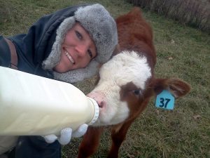 Michelle with a baby bottle calf from her farm! 